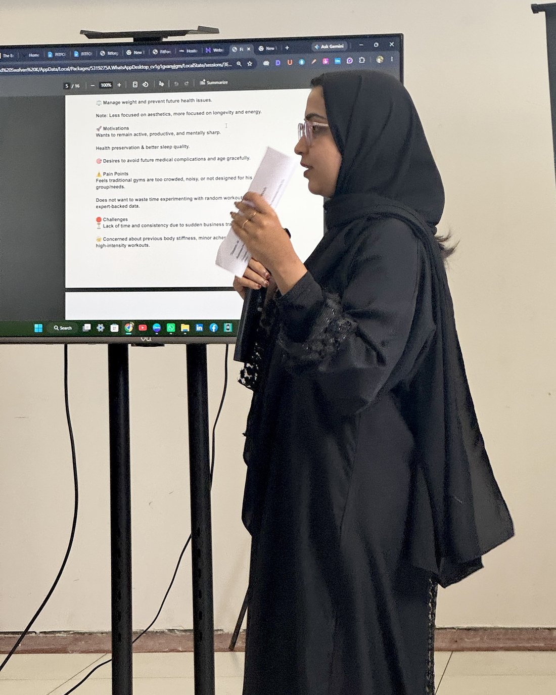 Ayshath Adila Fairoz presenting her Med7 Pharmacy competitor analysis, showing a customer persona slide on screen